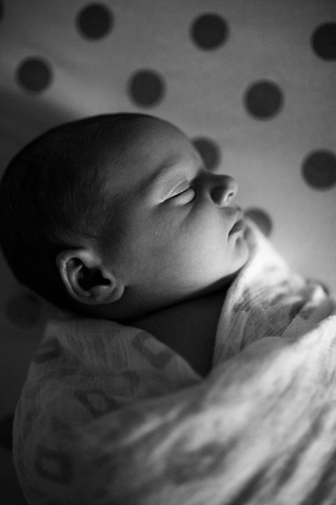 black and white, swaddled newborn, polka dot crib sheet