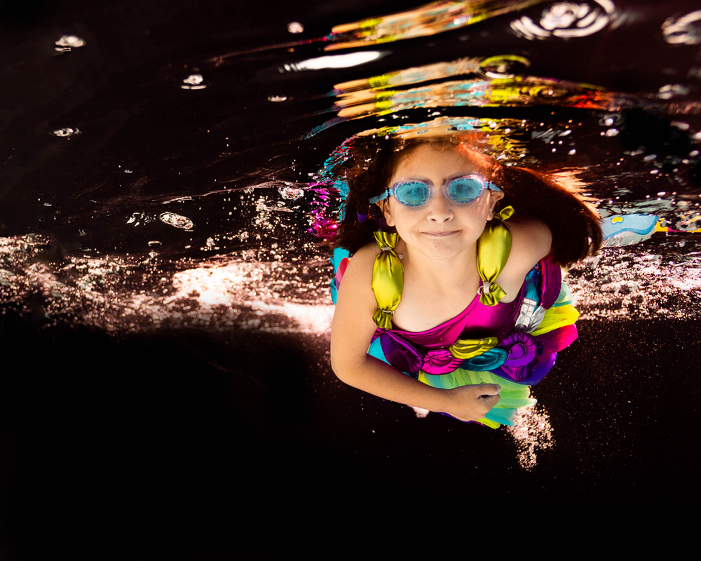black backdrop, underwater photo, lollipop dress, Chasing Fireflies, blue goggles, girl