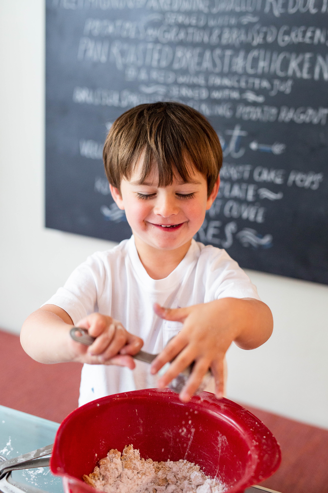 toddler boy baking, red mixing bowl