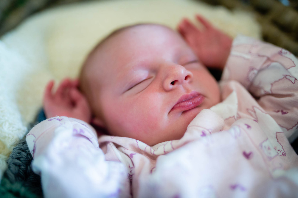 newborn baby girl with hands up